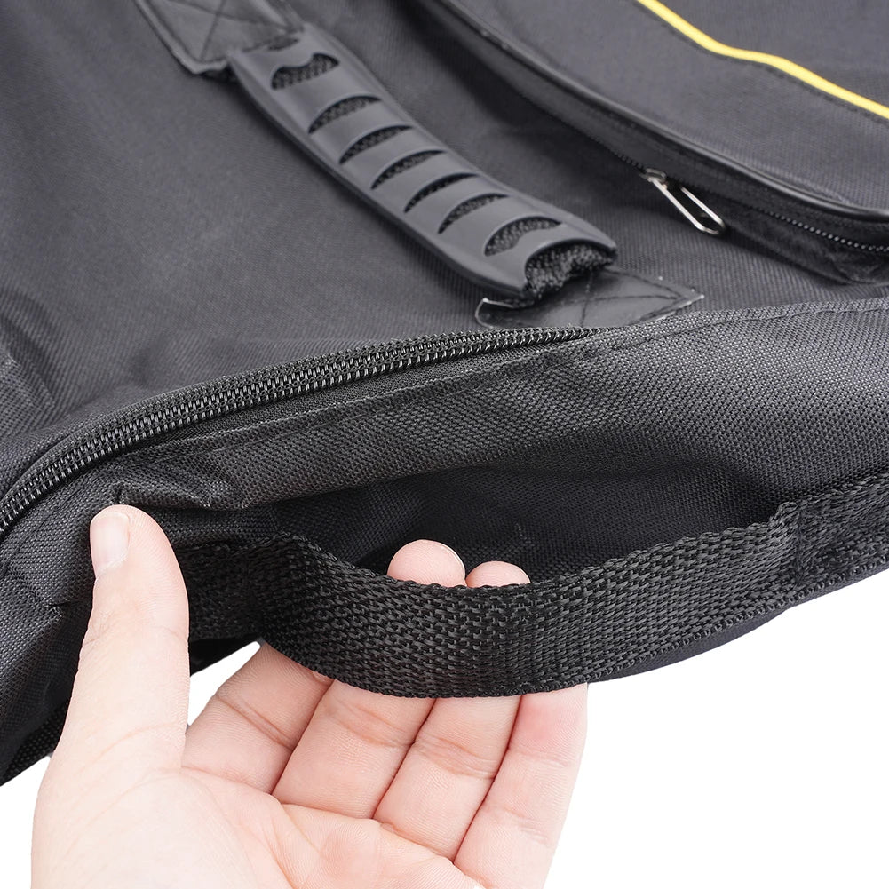 A hand is opening a black padded water-resistant guitar bag, showing the zipper and strap details.