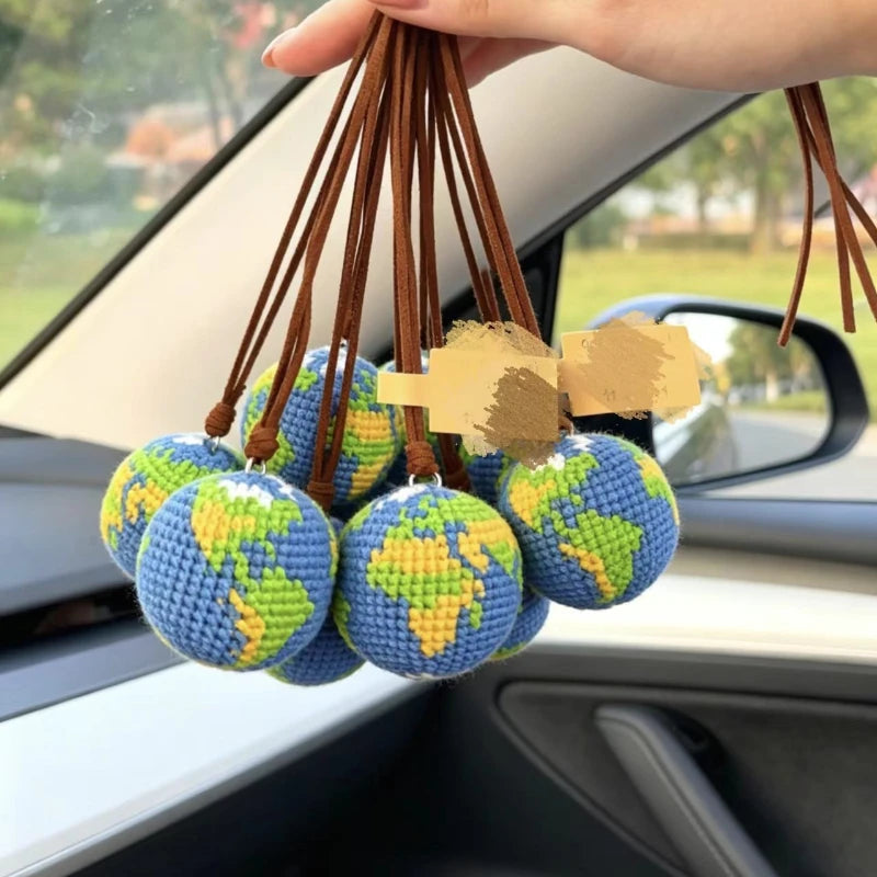 Handcrafted crochet earth keychain charms featuring globe designs and brown leather tassels