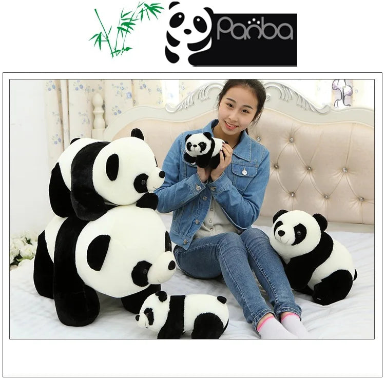 A woman is sitting on a bed with two panda plush toys, one of which is being held to her chest.