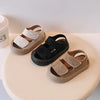 A set of toddler soft-soled sandals for boys and girls in beige and black colors displayed on a white surface.