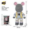 A gray bear figure made of micro building blocks with pink ears and yellow and blue accents.