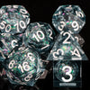 A collection of clear polyhedral dice with a galaxy finish are displayed on a dark surface.