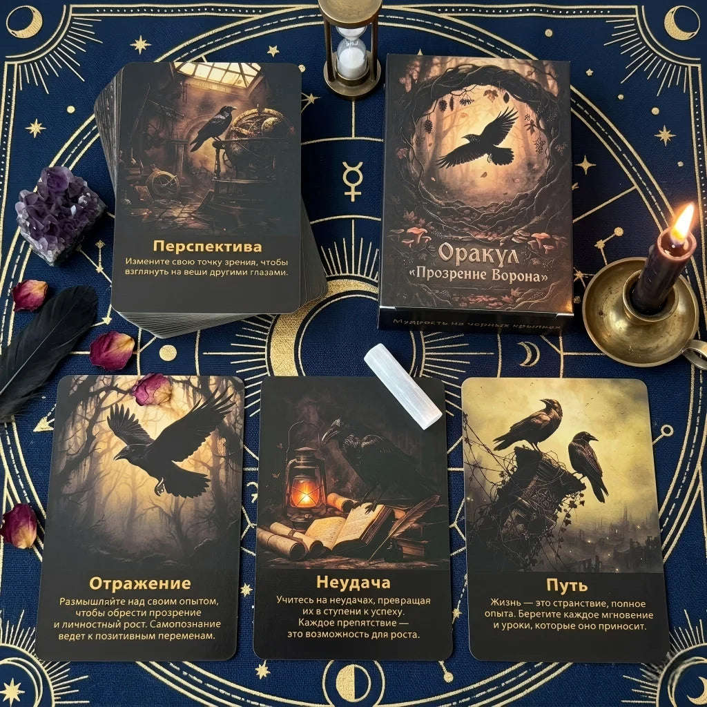 A collection of dark-themed oracle cards featuring imagery of ravens and spiritual themes set on a blue fabric.