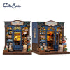 A detailed 3D wooden book nook kit featuring a shop facade with interior displays and LED lighting.