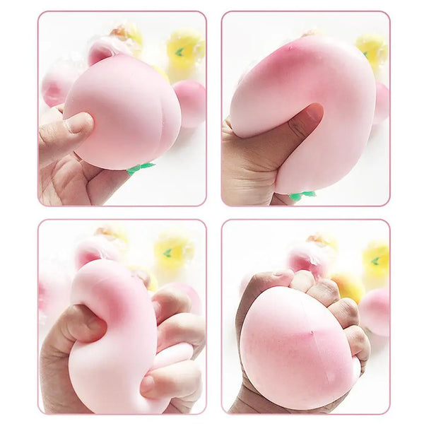 Hands hold a pink peach-shaped squishy stress relief toy.