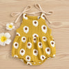 A yellow cotton romper for a baby girl with a white daisy floral print and adjustable ties.