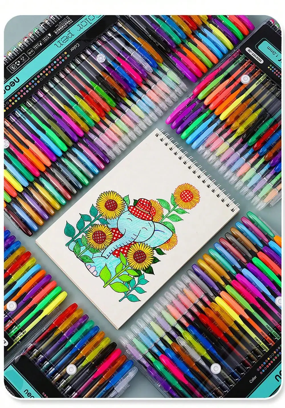 A collection of metallic glitter gel pens in various colors arranged on a white notepad and surrounding surfaces.