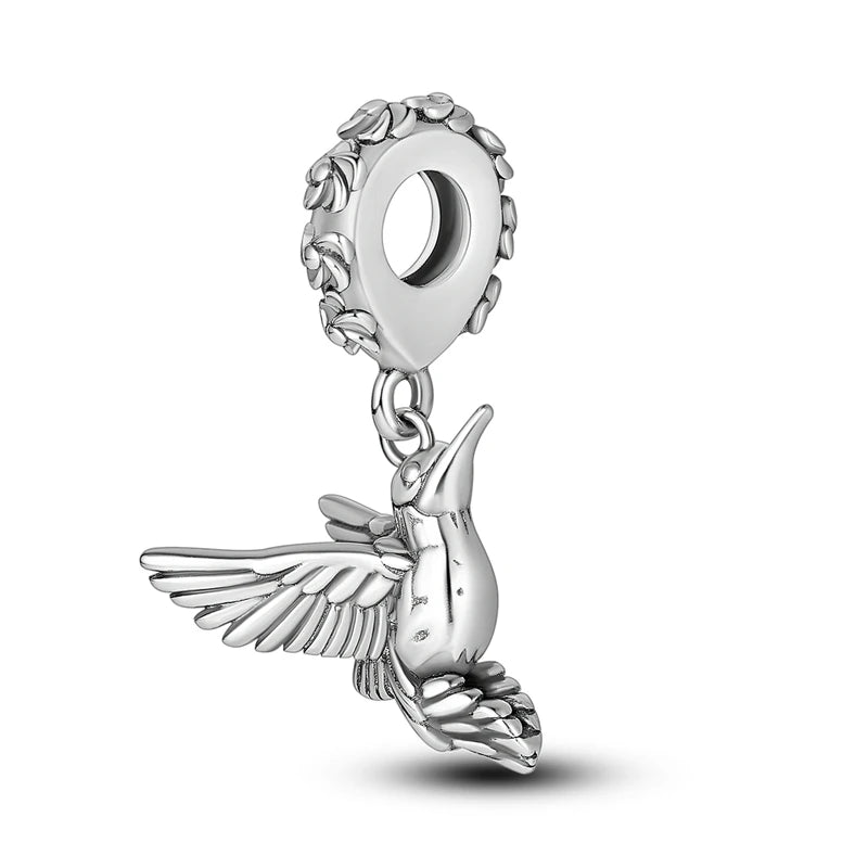 Sterling silver charm bead shaped like a bird with wings and a loop for bracelet making