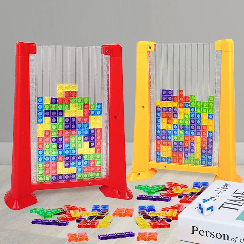 A set of red and yellow plastic building blocks and a clear acrylic frame for a 3D puzzle toy