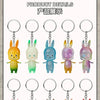 A collection of eight small, colorful rabbit-like figures from the Labubu series displayed on silver keychains.
