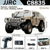 A desert yellow 1:12 scale RC off-road climbing vehicle with a remote control and accessories.