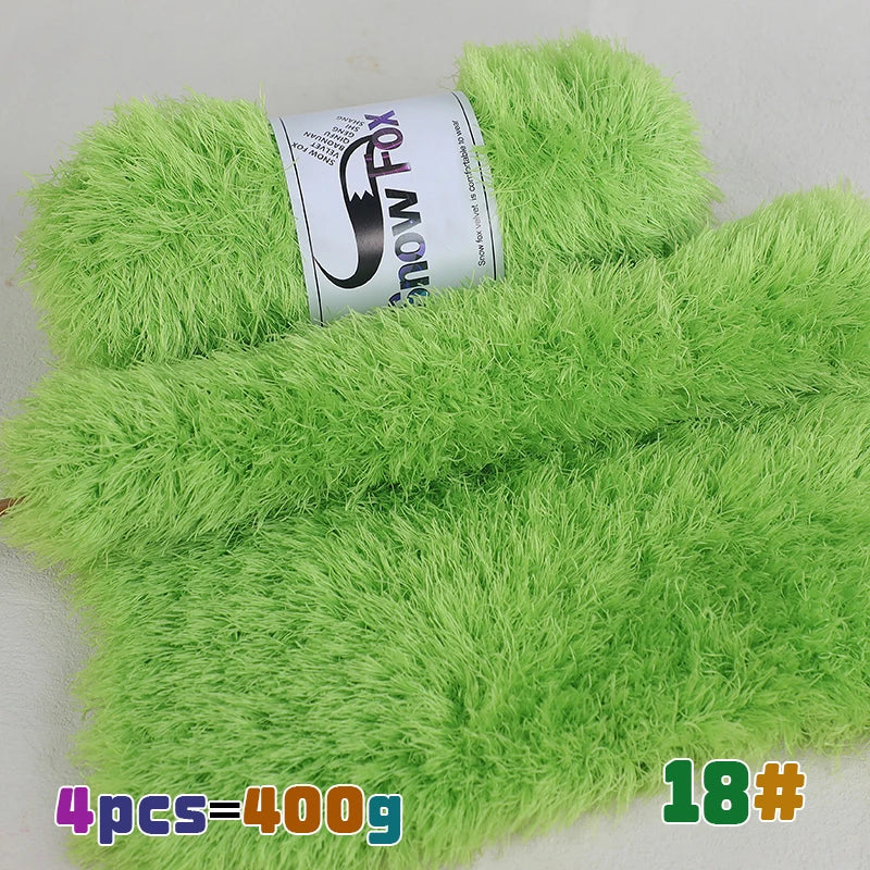 A bright lime green faux fur yarn product showing a roll of yarn and a swatch of the fluffy material.