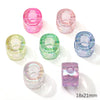 A collection of colorful acrylic alphabet beads in pink, green, and blue shades displayed on a white background.