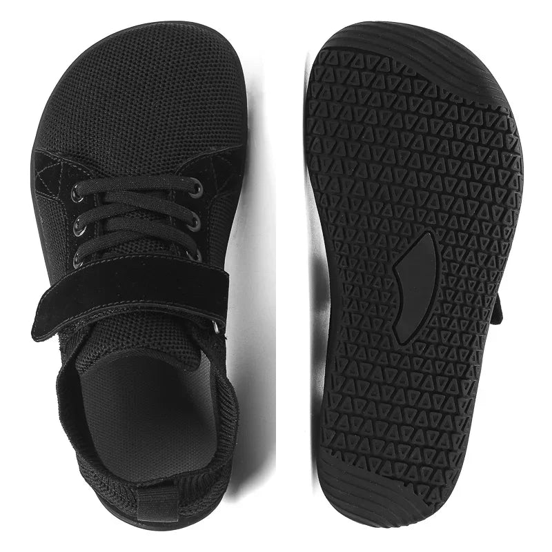 A pair of black minimalist barefoot sneakers shown from the top and bottom views.