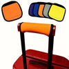 A set of neoprene luggage handle covers in various colors, including orange, blue, green, and yellow, shown with a red suitca
