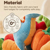 A close-up of a soft, blue plush toy and various colorful fabric shapes used for a Montessori sorting toy set.
