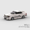 A white classic rally car model built from LEGO bricks, shown in a side view.
