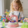A young girl is assembling a fabric flower bouquet craft kit, featuring colorful flowers and pink components.