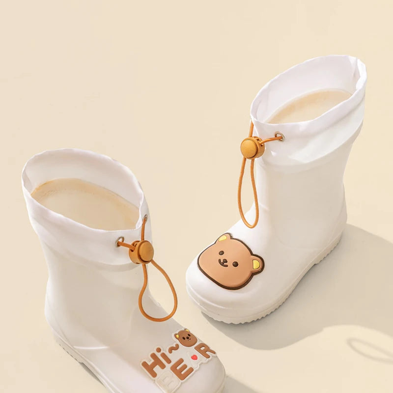 A pair of white kids' waterproof bear rain boots with anti-slip soles and leather accents.