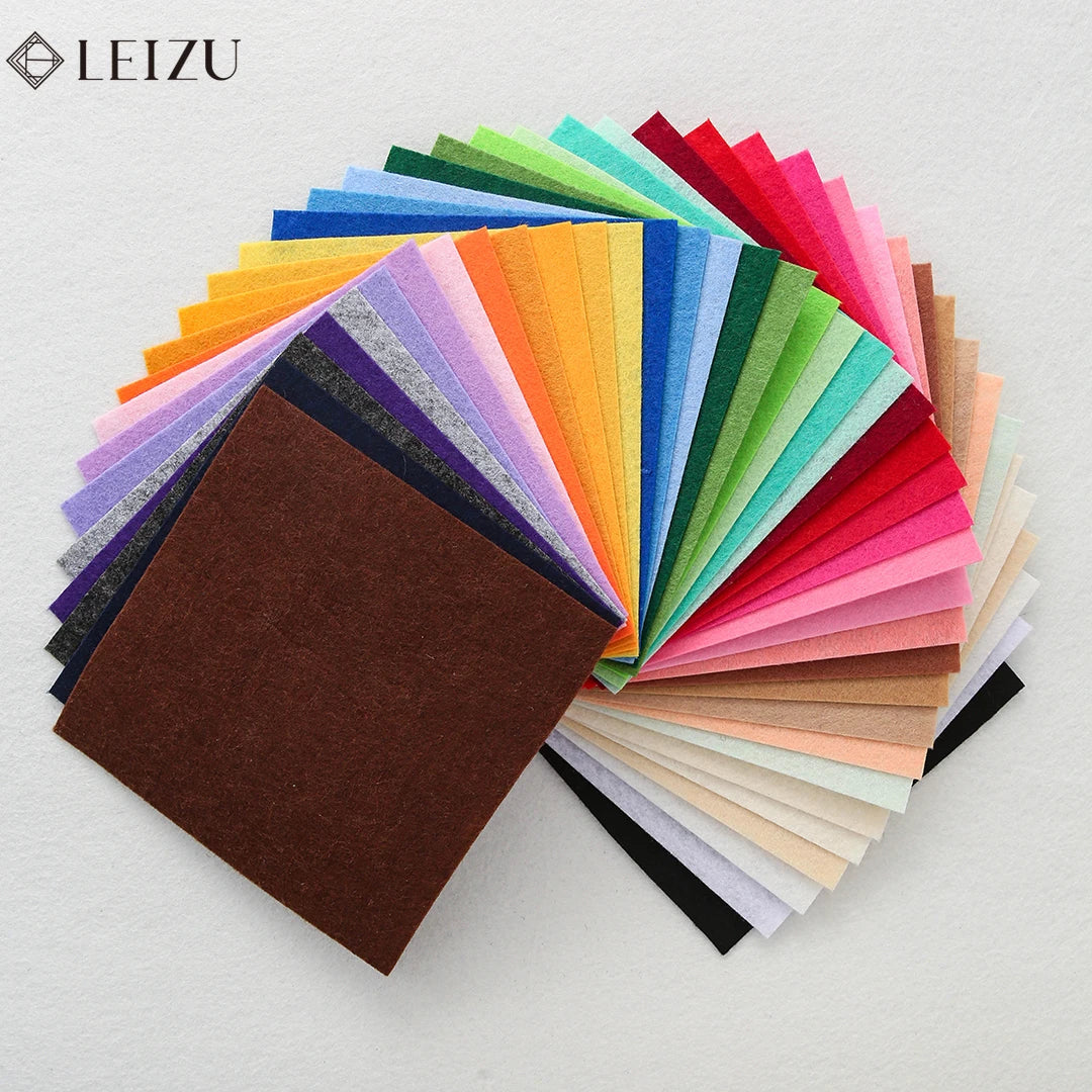 A fan of colorful non-woven felt fabric sheets displayed in a vibrant spectrum of colors.