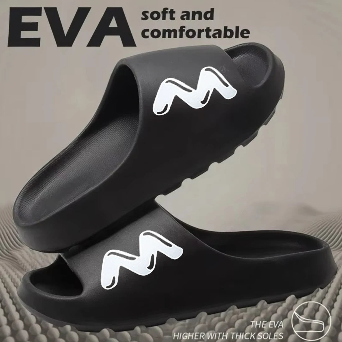 A pair of black EVA slide slippers with a non-slip sole featuring a white 'M' logo.