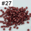 A pile of 1000 small, cylindrical fuse beads in various shades of reddish-brown and maroon.