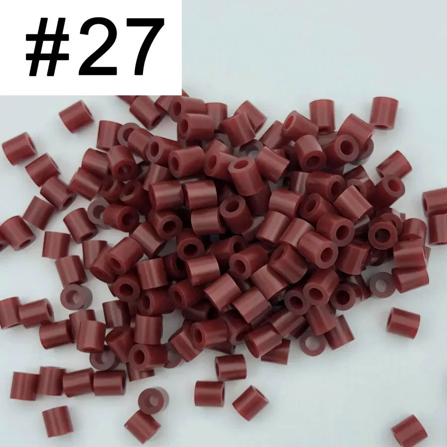 A pile of 1000 small, cylindrical fuse beads in various shades of reddish-brown and maroon.
