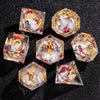 A set of liquid core polyhedral dice in clear crystal with gold accents and red floral designs.