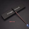 A dark wooden box with 'Magic Wand' inscribed, next to a slender wand with a glowing tip.
