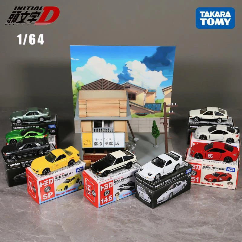 A collection of Takara Tomy 1/64 die-cast sports car models displayed in front of a scenic background.