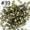 A pile of 1000 assorted 5mm fuse beads in various gold and black colors for craft projects.