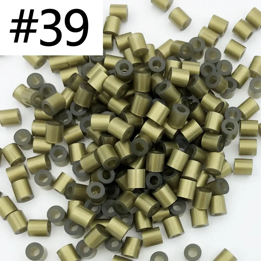 A pile of 1000 assorted 5mm fuse beads in various gold and black colors for craft projects.