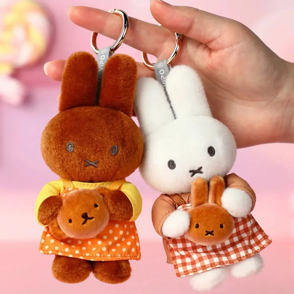 A pair of Miffy Bakery Series blind box keychains featuring a rabbit character in orange and yellow clothing.
