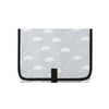 A white portable foldable waterproof diaper changing pad with a black trim and a central strap.