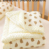A double-sided usable soft fleece beanie blanket for toddlers with a light yellow background and brown bear pattern.