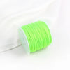 A roll of bright lime green macrame cord for jewelry making and crafts is shown against a white background.