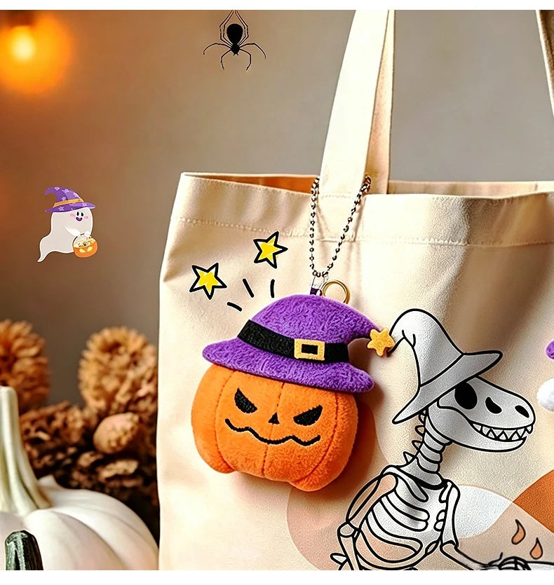 A beige tote bag features a Halloween plush keychain set including a ghost, pumpkin, and bat charm.