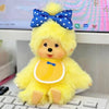 A yellow fluffy cartoon plush toy with blue accents sitting on a keyboard.
