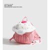 A pink mini backpack with a white mushroom design and pink straps is shown against a light gray background.