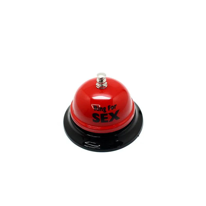 A red metal table bell used for couples' games.