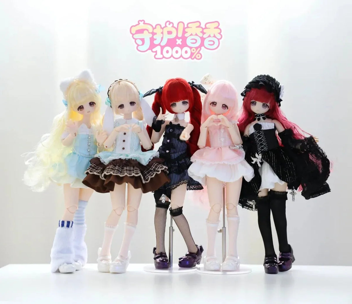 A collection of five articulated collectible figures featuring various hair colors and outfits.