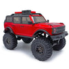 Un véhicule RC crawler rouge avec des accents noirs et de grands pneus tout-terrain.