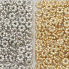 A close-up view of a set of 200 snowflake spacer beads for jewelry making, featuring silver and gold colored beads.