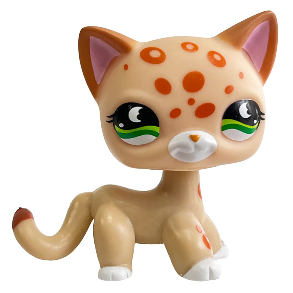 A charming bobble head figurine of an orange cat with white paws and green accents.