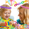 A young child and a woman interact with colorful telescopic pop tubes for sensory play.