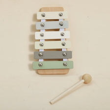 A set of five wooden bear musical instruments with different colored bars mounted on a wooden board.