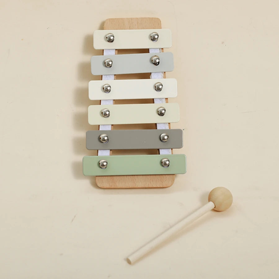 A set of five wooden bear musical instruments with different colored bars mounted on a wooden board.