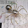 A silver steampunk metal spider assembly kit with long legs and a spherical body is shown on a white background.