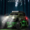 A green off-road RC car with LED lights driving through a forest setting.