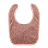 A soft, pink, fuzzy baby bib with an adjustable snap closure.